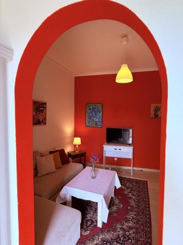 a living room with an archway with a couch and a table at Art & Motion Union - Guest Room 4 in Andros