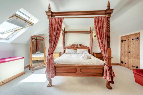 a bedroom with a canopy bed and a mirror at 1 Bed in Bideford oc-labdr in Woolfardisworthy