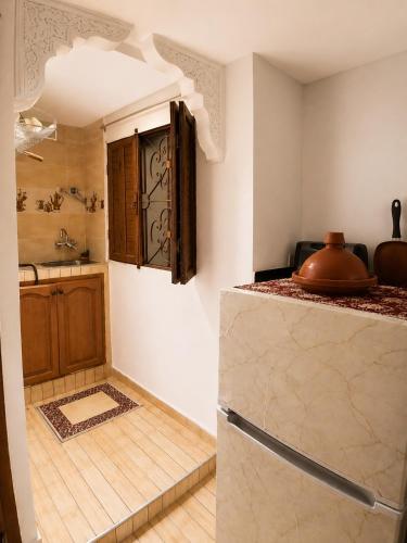 a kitchen with a refrigerator and a sink at Dar Amine in Rabat