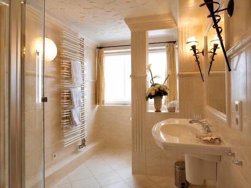 a bathroom with a sink and a glass shower at Hotel Altes Rathaus in Ostfildern