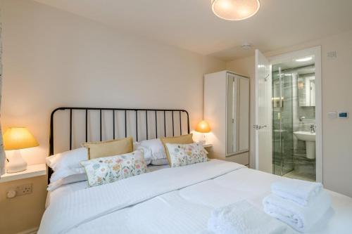 a bedroom with a large white bed and a bathroom at 1 Bed in Lytham St. Annes oc-86044 in Saint Annes on the Sea