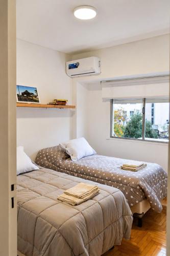 two beds sitting next to each other in a room at Las Heras in Bahía Blanca