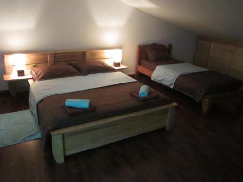 a hotel room with two beds and two tables at LE Colibri in Le Dix-Septième