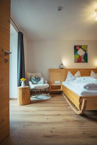 a bedroom with two beds and a couch and a table at Appartementhaus Bergkristall in Kartitsch