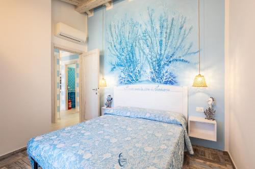 a bedroom with a bed and a painting on the wall at Blue Moon in Castelsardo