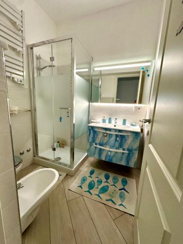 a bathroom with a sink and a shower and a toilet at Blu Suite Ostia in Lido di Ostia