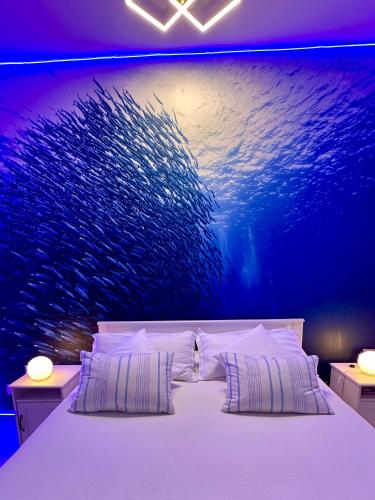 a bedroom with a large fish painting on the wall at Blu Suite Ostia in Lido di Ostia