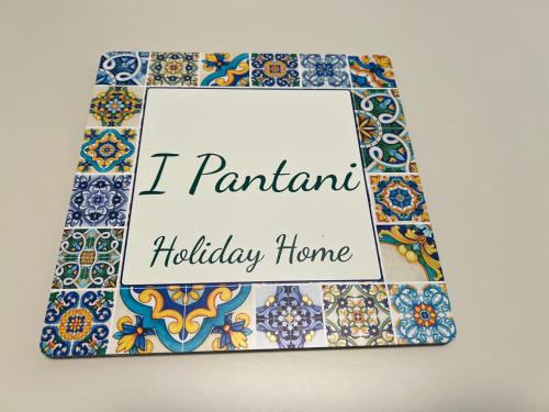 a picture of a tiled wall with a sign that reads i permanent holiday home at I Pantani in Schisò