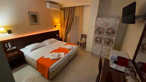 a hotel room with a bed and a television at Nefeli Boutique Hotel in Agios Kirykos