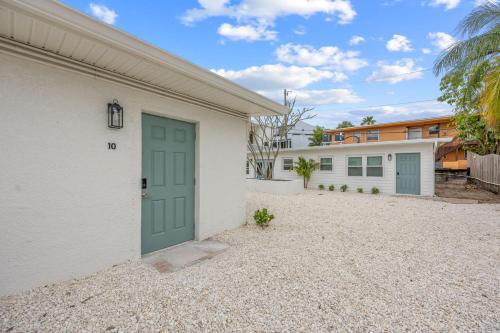 a garage with a green door and a building at Dune Drift in Cocoa Beach