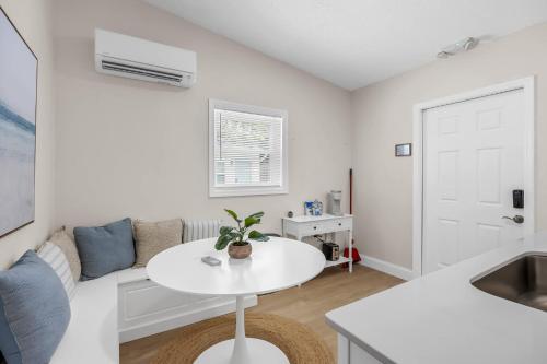a white living room with a white table and a couch at Dune Drift in Cocoa Beach