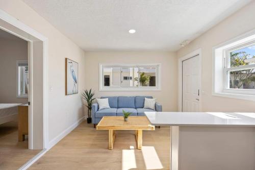 a living room with a blue couch and a table at Anchor House in Cocoa Beach