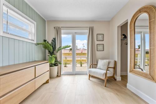 a living room with a dresser and a mirror at Breakwater Bungalow in Cocoa Beach