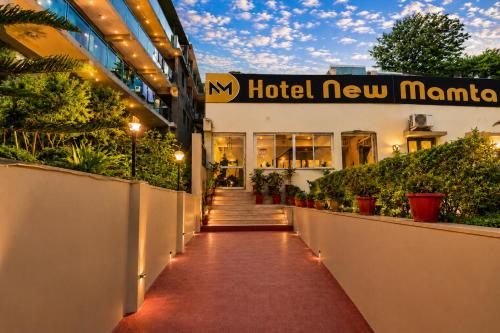 a hotel new manila with a walkway in front of a building at Hotel New Mamta by SSH 350 Metres from Nakki Lake in Mount Ābu