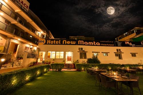 a hotel new marina with tables and chairs at night at Hotel New Mamta by SSH 350 Metres from Nakki Lake in Mount Ābu