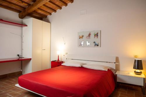 a bedroom with a red bed with a red blanket at Lilium B&B Villa Patrizia - Con piscina e parcheggio by Mamo Florence in Itri
