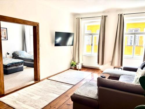 a living room with a mirror and a couch at Apartmán Růženka Písek in Písek
