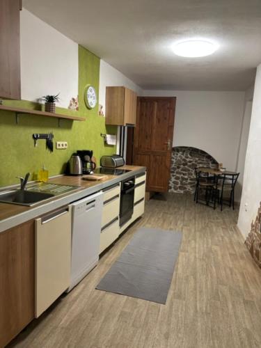 a kitchen with a sink and a stove top oven at Apartmán Růženka Písek in Písek