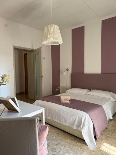 a bedroom with two beds and a laptop on a table at Giove Rooms in Verona