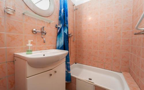 a bathroom with a sink and a bath tub at Penzion Vápenka in Horní Maršov