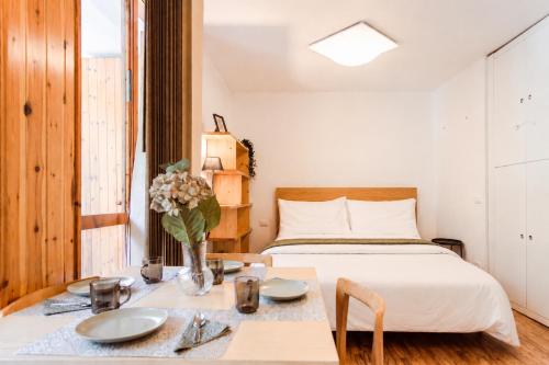 a bedroom with a bed and a table with plates on it at Loft a Canazei vicino alle piste vista Marmolada in Alba di Canazei