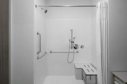 a shower in a bathroom with a shower curtain at StudioRes by Marriott Mesa in Mesa
