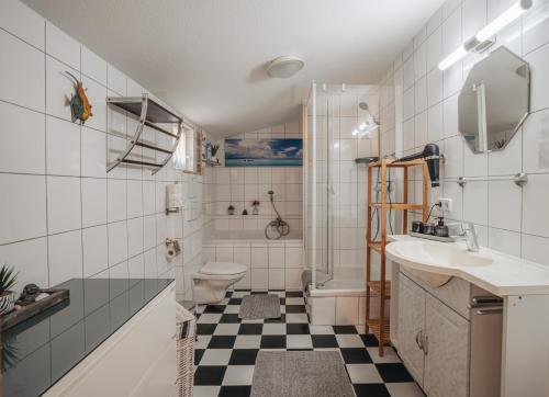 a bathroom with a sink and a toilet and a shower at Ferienwohnung Leipzig- Hirschfeld Apartments in Leipzig