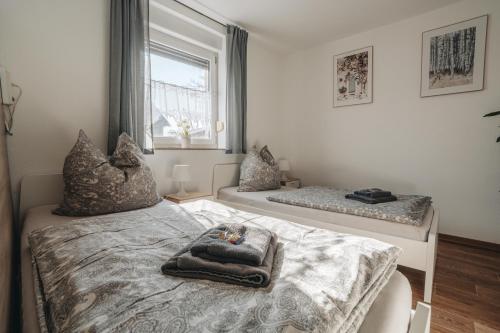a bedroom with a bed and a window at Ferienwohnung Leipzig- Hirschfeld Apartments in Leipzig