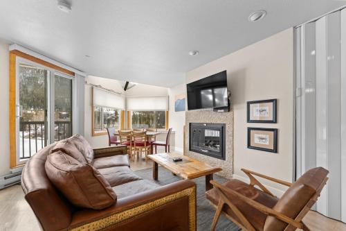 a living room with a couch and a fireplace at Lakeside #1496 in Keystone