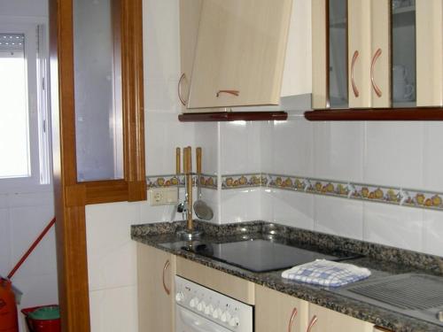 a kitchen with a sink and a counter top at APCOSTAS - Puerto Playa in Los Urrutias