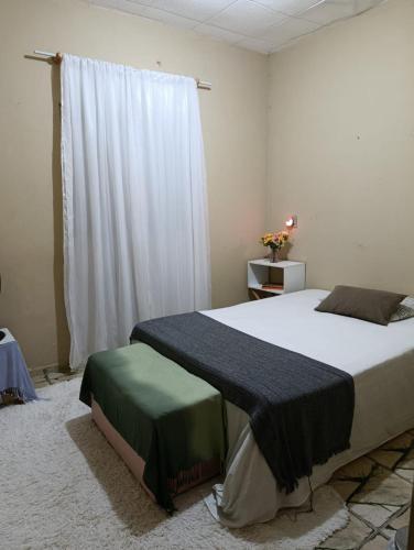 a bedroom with a large bed and a window at SPA Alexandre Maia quarto 2 in Juazeiro do Norte