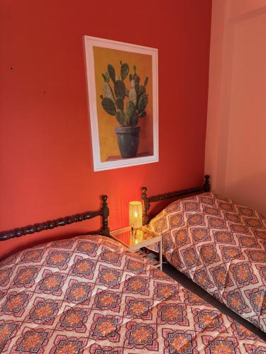 a bedroom with a bed and a picture on the wall at Art & Motion Union - Guest Room 5 in Andros