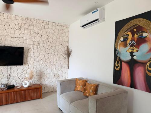 a living room with a couch and a painting on the wall at U PARADISU VILLAS - Private Pool in Jambiani