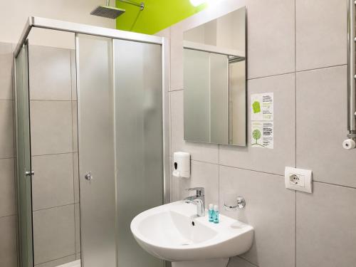 a bathroom with a sink and a shower at Comfort Hotel in Odesa