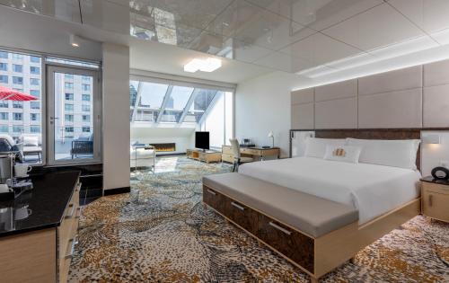 a bedroom with a large bed and a living room at Le Mount Stephen in Montreal
