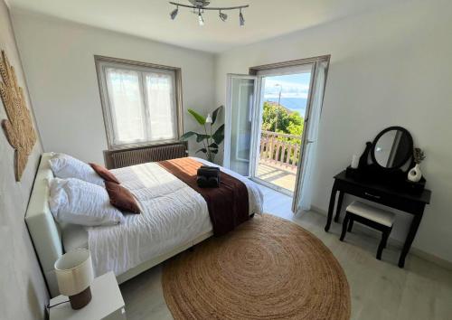 a bedroom with a bed and a mirror and a table at VILLA LÉMAN - Panoramic lake view in Évian-les-Bains