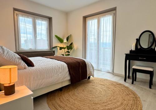 a bedroom with a bed and a mirror and a piano at VILLA LÉMAN - Panoramic lake view in Évian-les-Bains