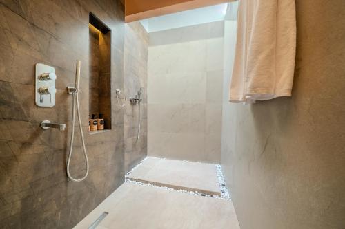 a bathroom with a shower with a walk in shower at Villa Lumora Maldives in Rasdhoo