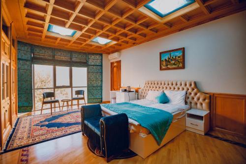 a bedroom with a bed and a chair in it at White House SPA Hotel in Baku