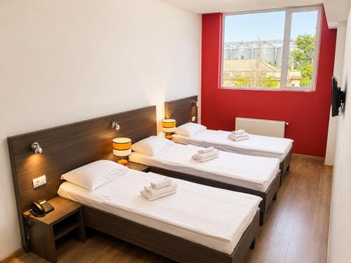 three beds in a room with a window at Mare nero in Odesa