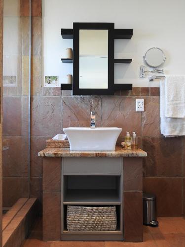 a bathroom with a sink and a mirror at Classical View Guesthouse in Mossel Bay