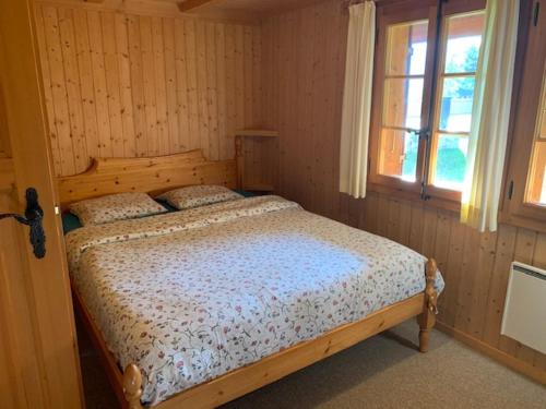 a bedroom with a wooden bed in a room at Chalet Castor in Les Diablerets