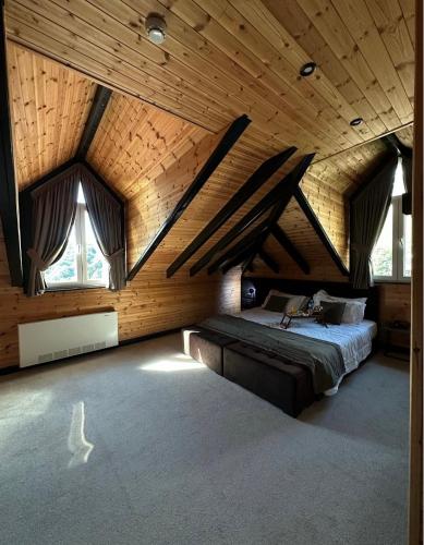 a bedroom with a large bed in a wooden ceiling at Eurobushi Hotel in Kolgecaj