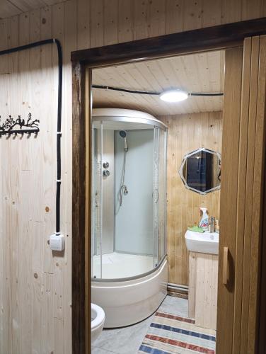 a bathroom with a tub and a toilet and a sink at Мисливський Дворик in Solochyn