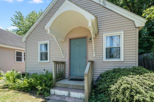 a house with a blue door and a porch at Chris Cottage 3 in Chincoteague