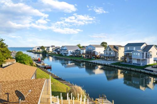 a row of houses next to a river at Dock Holiday in Greenbackville