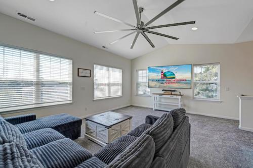 a living room with couches and a flat screen tv at Dock Holiday in Greenbackville