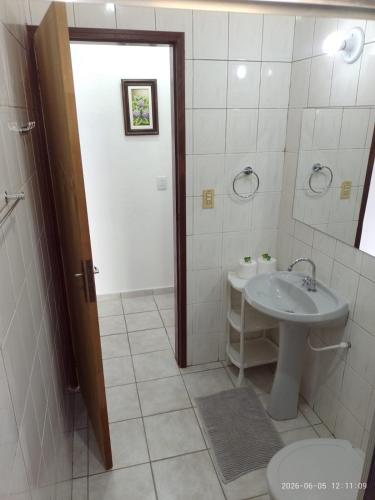 a bathroom with a sink and a toilet at Recanto Mosaico in São Sebastião