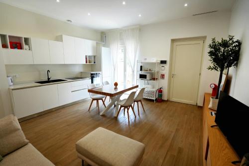 a kitchen and living room with a table and chairs at Casa Federica by MOH in Grottaglie