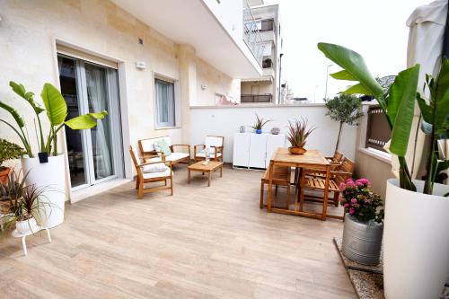 an apartment patio with plants and tables and chairs at Casa Federica by MOH in Grottaglie